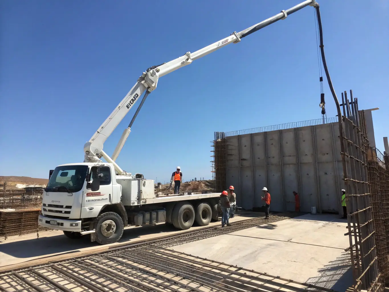A self-loader truck lifting a large container at a construction site, showcasing the versatility and efficiency of self-loader operations.